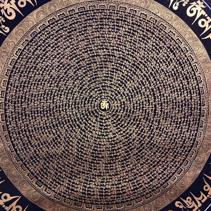 Close-up of the mantra mandala, thousands of tiny painted syllables in gold.