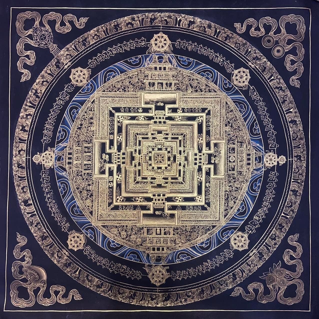 Kalachakra mandala painted in gold on a black ground.